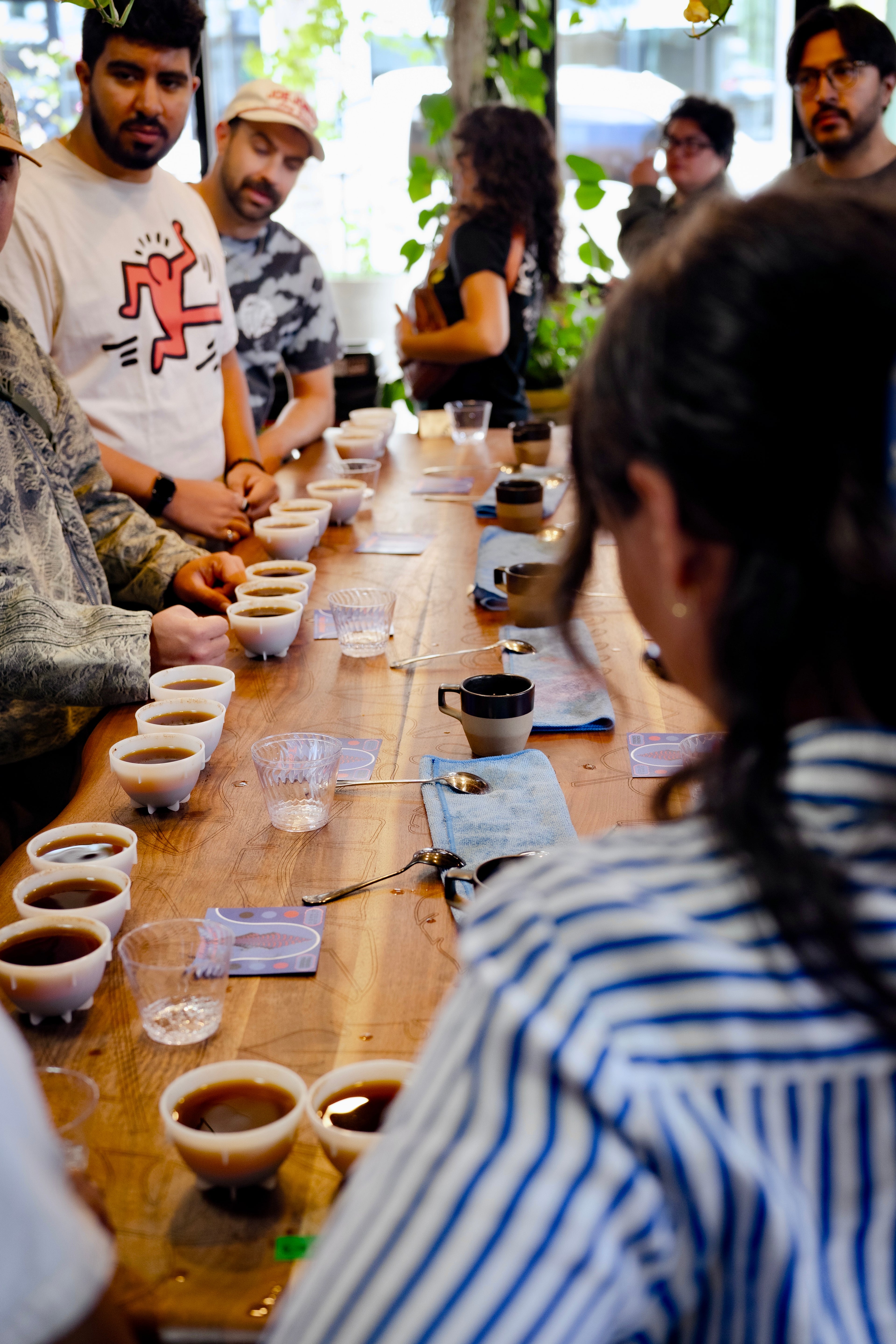Long table of guests seated for a cupping